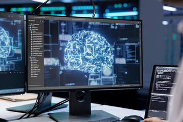 Fototapeta premium Software developer working in data center with artificial intelligence technology to process massive datasets, close up. IT professional in server hub storing data used for deep learning