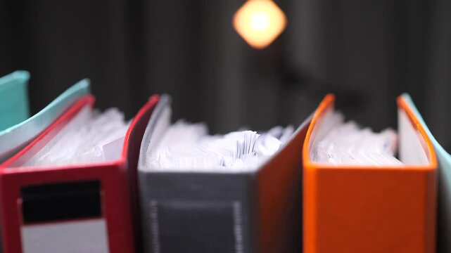 Colorful binders full of paperwork representing office work, Archive, storage