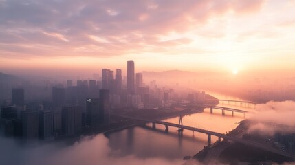 Naklejka premium Misty sunrise over city skyline and river.