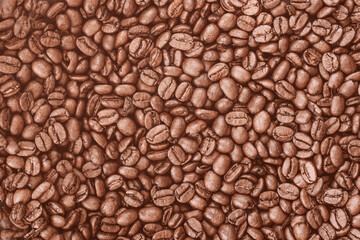 Roasted coffee beans background. Concept of coffee production and caffeine energy