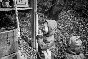 Little girl praying at a shrine