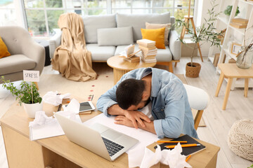 Stressed young man working at home