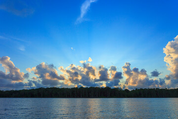 Sun rays trough clouds during a sunset at Jiquilisco Bay in El Salvador