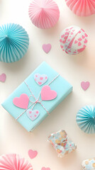 A pastel-themed gift with heart decorations surrounded by colorful paper accents.