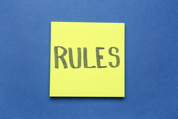 Sticky notes with word RULES on blue background