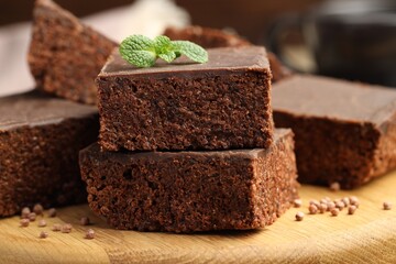 Delicious chocolate puffed rice bars and mint on wooden table, closeup