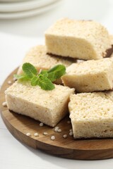 Delicious puffed rice bars and mint on white wooden table, closeup