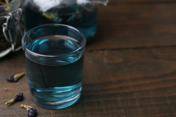 Delicious butterfly pea flower tea on wooden table. Space for text