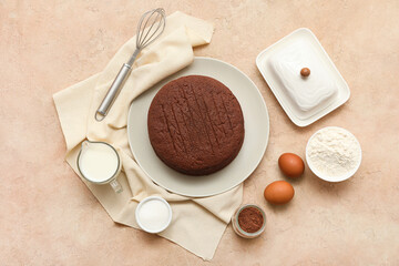 Composition with sponge cake layers, ingredients and whisk on color background