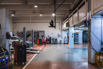 Car repair shop with professional equipment and cars being repaired