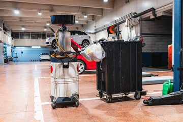 Oil collection tank and toolbox in a car repair shop