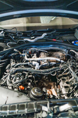 Fototapeta premium Car engine showing turbocharger and manifold in repair shop