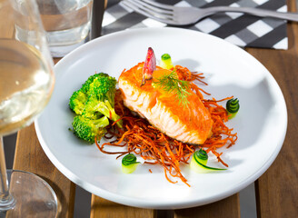 Sea food - salmon steak on carrot brush with fresh broccoli and figs
