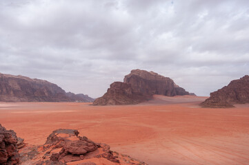 A desert landscape with a mountain in the background