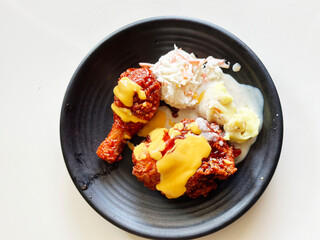 Plate of fried chicken with coleslaw and mashed potato