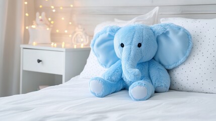 Adorable blue elephant plush toy on cozy bed with warm ambient lighting