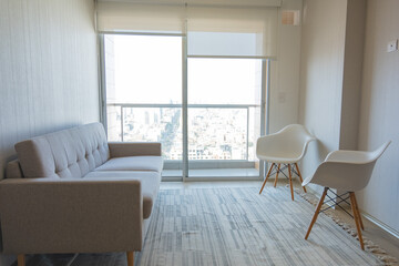 A living room with a white couch and two white chairs. New home concept.