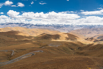 Winding Roads of Friendship Highway En Route to Mount Everest in Tibet and Nepal, blue sky with...