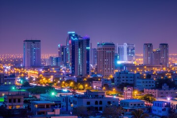 Nighttime city skyline with illuminated buildings and streets.