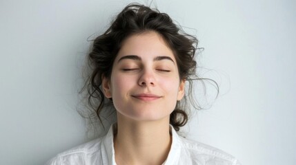 A serene young woman with closed eyes, expressing calm and tranquility.
