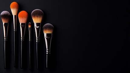 Makeup brushes on black background.