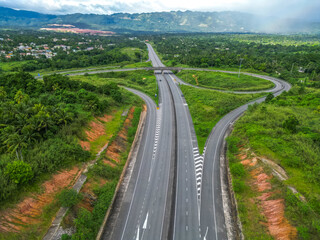 North South tool road highway St Catherine Kingston to Mammee Bay St Ann Ocho Rios Montego Bay North Coast Jamaica with lush greenery and Caribbean sea