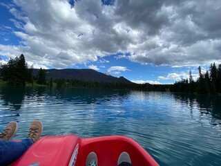 canoe on lake with mountain view