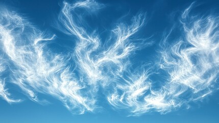 Obraz premium Beautiful wispy clouds against a vibrant blue sky create a serene and tranquil atmosphere, perfect for conveying peace and calm in visuals.