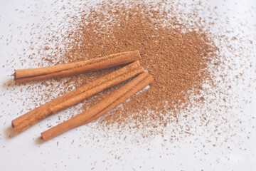 cinnamon sticks and powder on white background