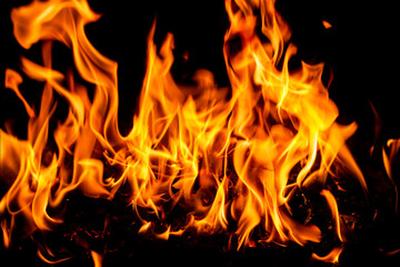 Fototapeta premium Fire flame background. Hell bonfire. Texture of fire on a black background. Blaze flames background for banner. Burning flames. Fire texture.