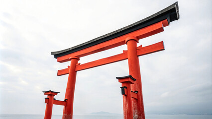 A towering red wooden temple gate against a serene blue sky, a symbol of ancient Japanese architecture
