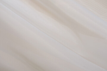 Soft fabric drapes in neutral tones creating a calming atmosphere indoors