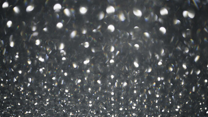 Silver bokeh. Grey bokeh effect. Shining background. Blurry background with bokeh.