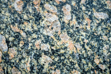 Close-up of a granite surface, illustrating the intricate mineral makeup and crystalline textures.