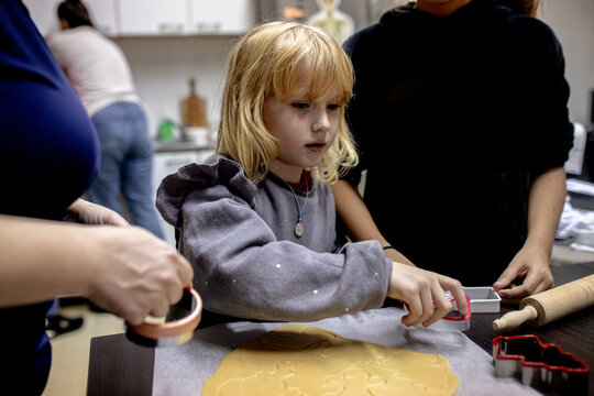 Child engages in baking cookies during a fun cooking activity in a cozy kitchen Christmas craft