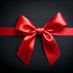 A perfectly tied red satin bow, presented on a solid black background to create an elegant visual impact