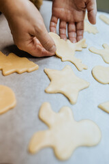 Baking festive shaped cookies with hand-cut dough during holiday preparations Christmas craft
