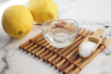Baking soda and whole lemon on table 