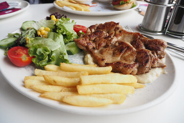 Delicious Grilled Chicken served with Crispy Fries and a Fresh Salad