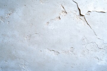 Fototapeta premium Cracked and textured light-colored wall surface.