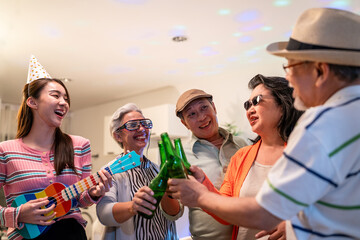 Group of Asian senior friend and young girl having night party in house.
