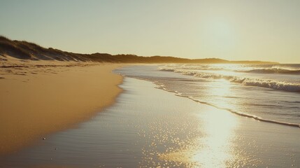 Obraz premium Tranquil Beach Scene with Gentle Waves and Soft Golden Light