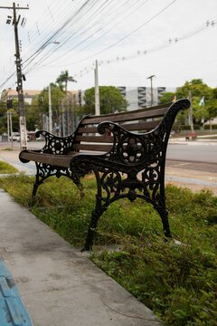 A weathered wooden bench with ornate cast iron