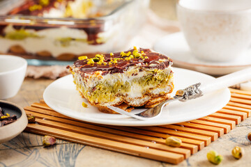 Homemade tiramisu with pistachio mousse and dark chocolate