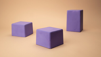 Obraz premium Purple boxes of different sizes lying on a beige background