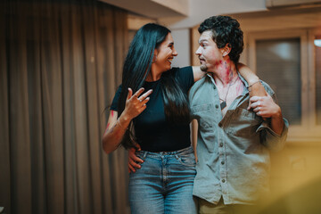 A joyful couple shares a light-hearted moment together indoors, exuding happiness and connection. They are embracing and smiling, creating a warm and casual atmosphere in a home setting.