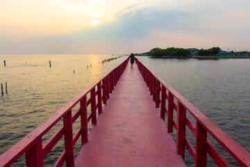 Red Bridge is A 700-meter long red wooden bridge, Samut Sakhon, dolphin viewing point, sunset, mangrove forest, fresh air located in Tambon Phanthai Norasing