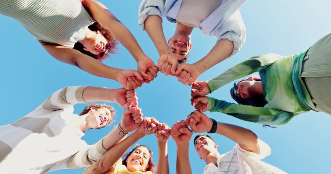 Fist bump, hands together and community with low angle of people for support, trust and connection. Diversity, helping others and solidarity with group of friends in nature for teamwork and partner