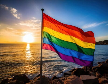 pride flag gay pride lgbtq rainbow colored flag by the ocean sunny blue sky beautiful beach sea view 