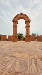 This photos showcase the iconic sandstone arch at Aksharbhoomi, a cultural and artistic landmark located in Bhubaneswar, Odisha, India.
